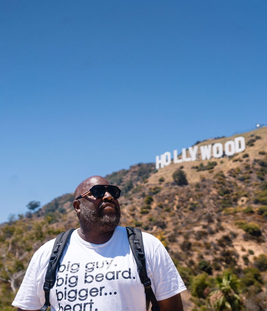 wedding photographer posing in front of hollywood sign