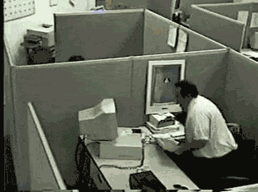 Man hitting computer with keyboard