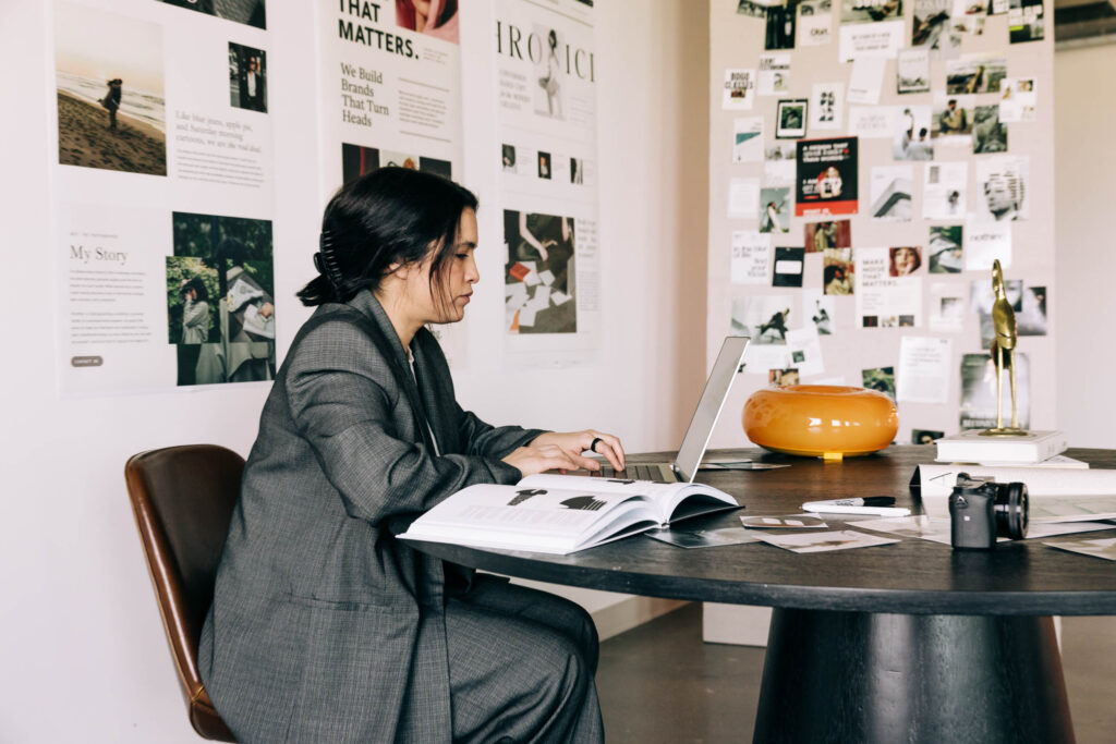 Woman working on a laptop in the Recover from Creative Burnout blog.