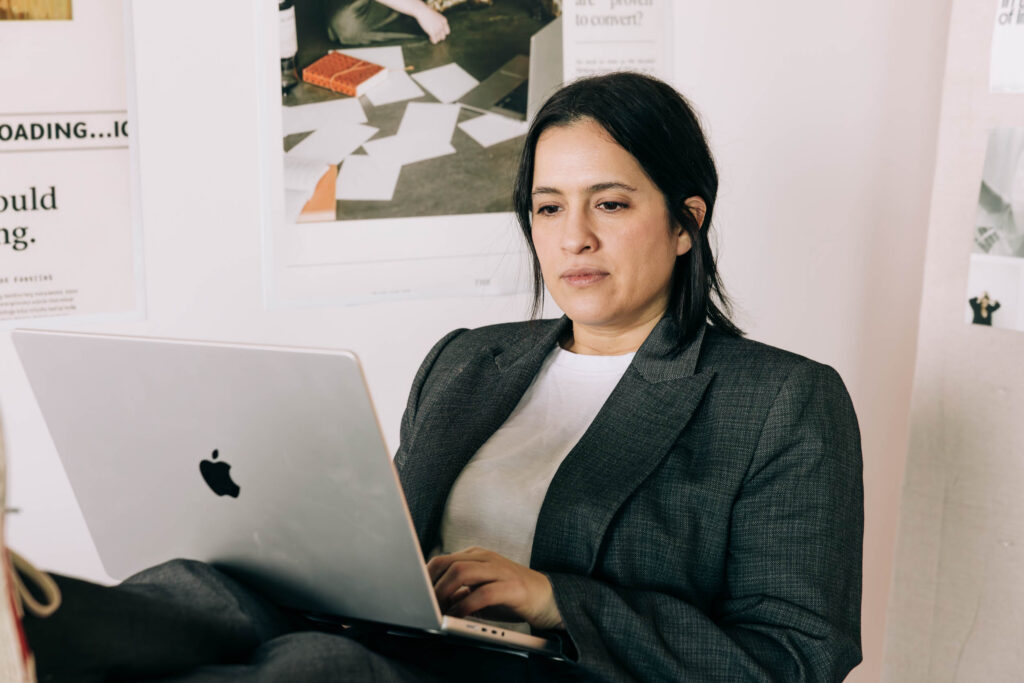 Woman working on a laptop in the Recover from Creative Burnout blog.